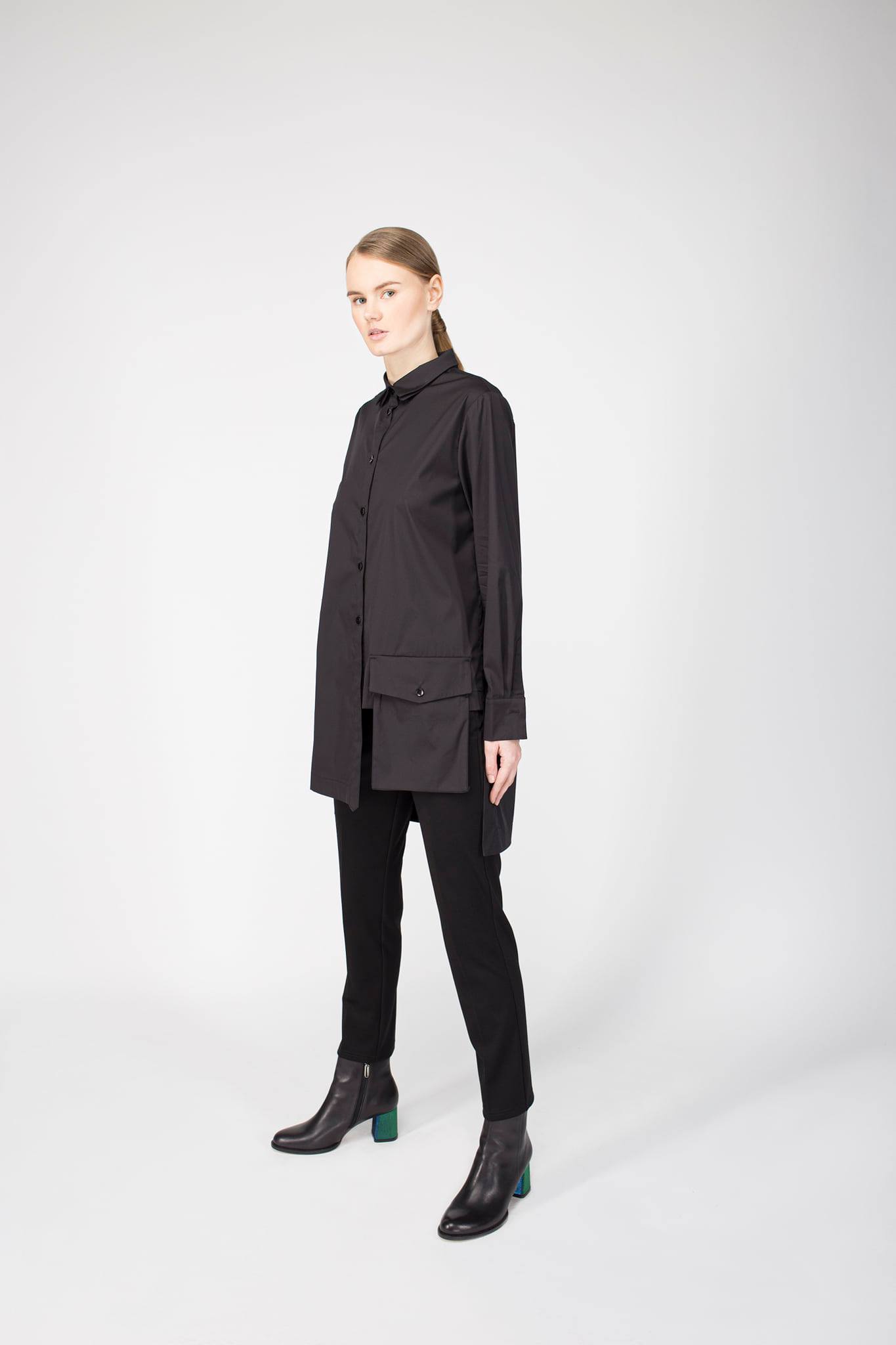 Person wearing a black outfit on a white background