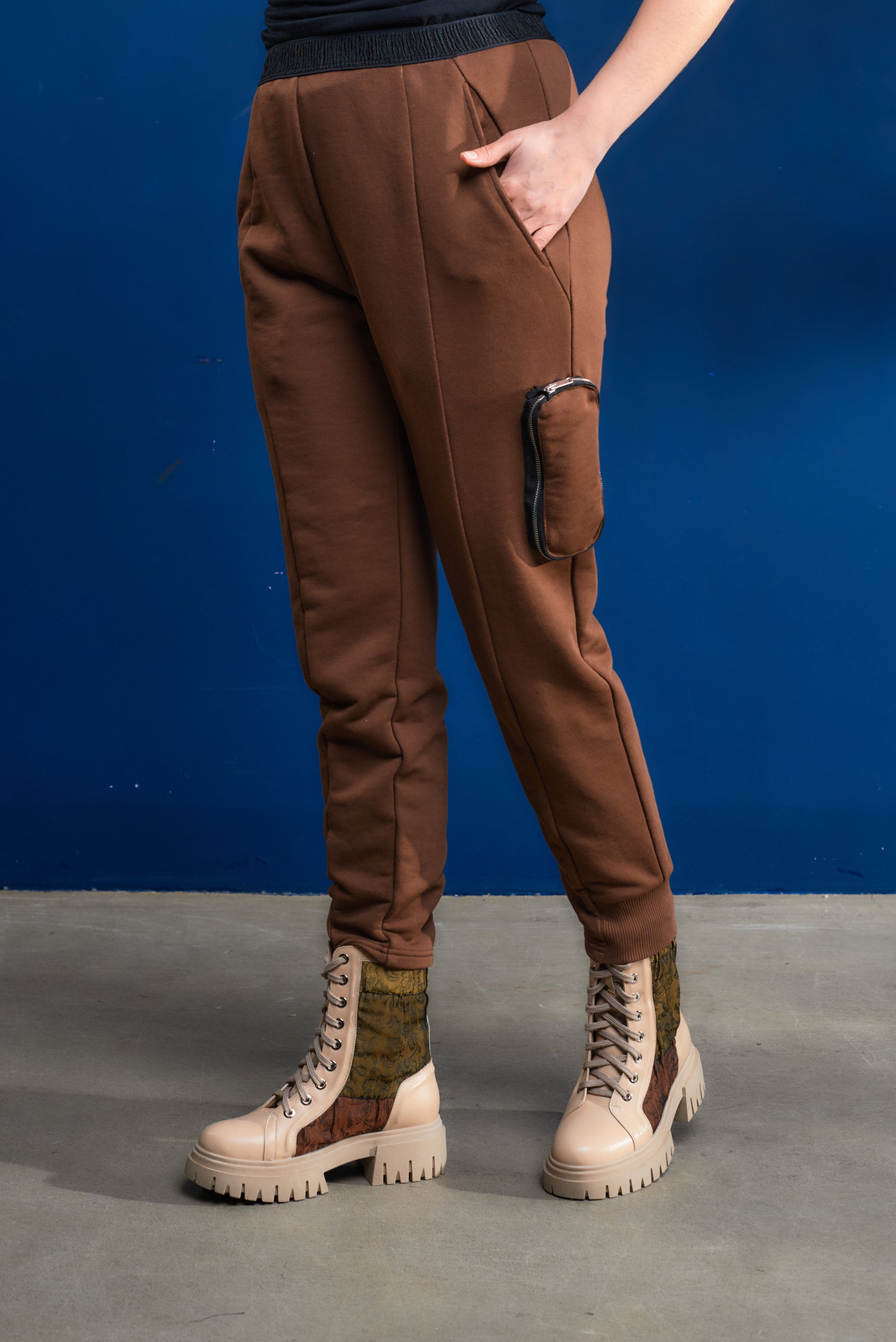 Brown cargo pants with a blue background