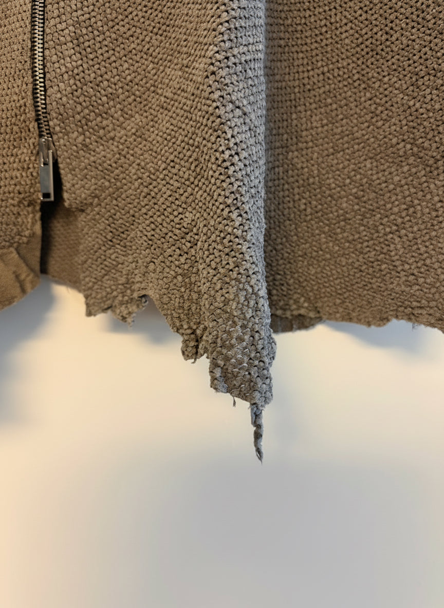 Textured grey leather with a zipper on a blurred background