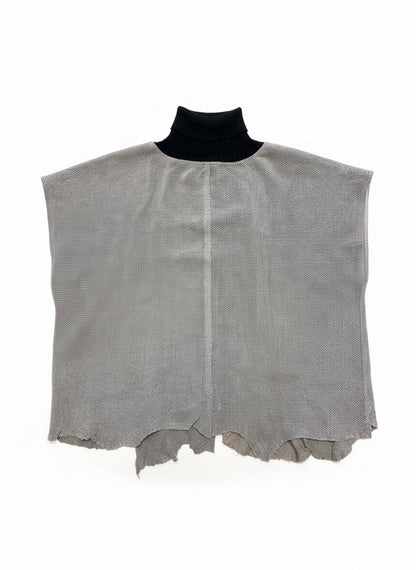 Gray textured leather piece on a wooden floor