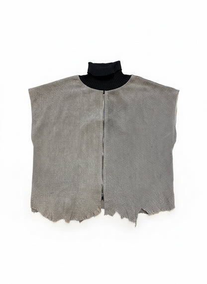 Gray leather piece with a black border on a wooden floor